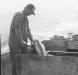Glenn Welch splits a fish aboard a hand lining boat.
