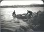 Elson and Wallace landing the canoe on shore along the Susan River.