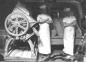 These two Carter Bakery employees are standing beside a dough mixer. 