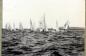 Rowing shells and snipe class sailing boats participating in a regatta on Sandy Lake. 