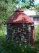 The old stone wellhouse located in front of the house