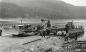 A cat scraper being loaded onto the Hydro barge below the dam