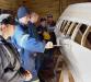 Boat building students and their instructor