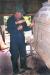 Boatbuilder, Ralph Coates, caulking his boat with oakum using a caulking iron and mallet.