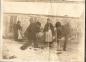 A car-roofed wood-frame shack titled "Before Christmas 1908".