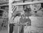 A group of miners with an official checking a map of the mine beside the lift