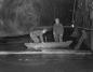 Two miners on one of the Brine Ponds underground in the Malagash Salt Mine