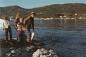 Children catch capelin from the harbour shore.