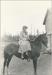 Mrs.Emily Thatcher on a horse.