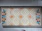 Old canvas mat with pattern similar to those used on hooked bedroom mats