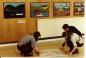 Two young women demonstrate how to make a mat at the Birmingham showcase