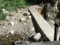 The decommissioned Trepanier Dam filled with rocks and gravel washed down the Creek