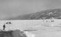 Cars and skaters on the frozen Okanagan Lake in front of downtown Peachland