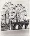 Gate designed by Jack Ray seen in front of a double Ferris wheel.