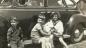 Paul, Kurt, baby Frieda, and Astrid Gossen sitting on the running board of their car