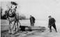 Abe Konrad and George Wiens loading beach sand to repair a muddy Island driveway