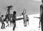 A group of young men playing snow volleyball at the top of the Blue Chair on Whistler Mountain. 