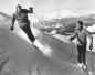 Jack Bright (left) finishes a powdery turn as Jim McConkey (right) watches with a smile.