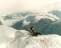 Two skiers enjoying a spectacular view from the top of Whistler Mountain. 