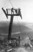 Construction workers installing a lift tower on the peak of Whistler Mountain.