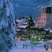 Visitors wandering along the Whistler Village Stroll in the snowy twilight.