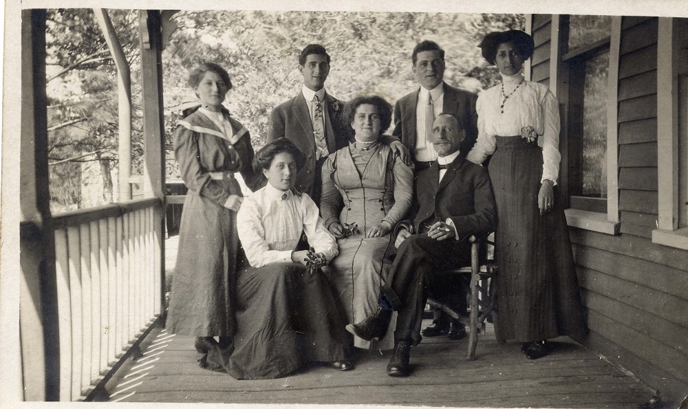 Family Group with Louis and Elizabeth Green seated in chairs with their five adult children – two sons and three daughters