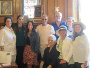 Seven women and two men gathered in front of display in Jewish Museum