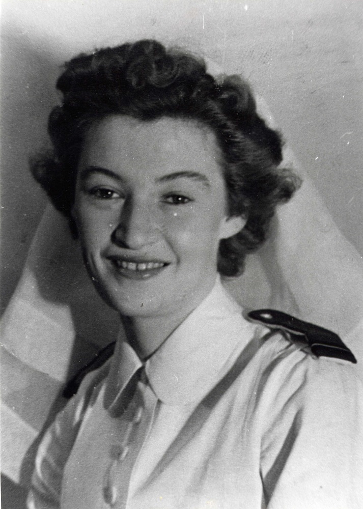 Formal portrait of young women in uniform of Nursing Sister with white veil and white uniform