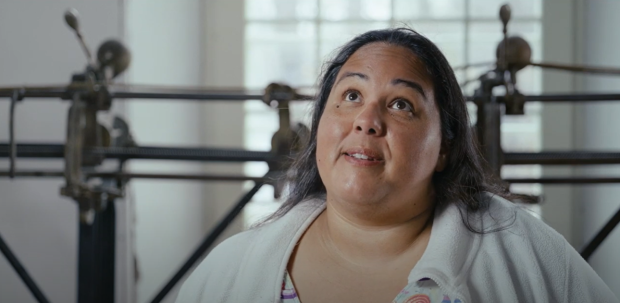 Close-up of a person in front of a track sewing machine, in interview format.