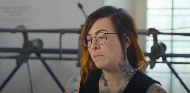 Close-up of a person sitting in front of a track sewing machine, in interview format.