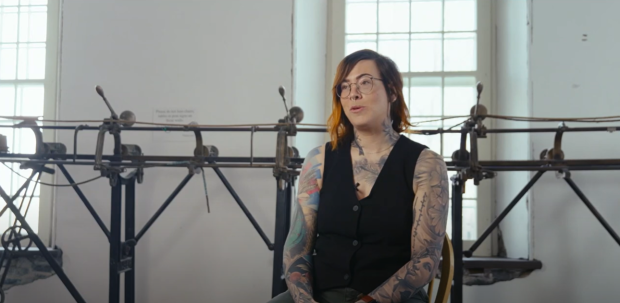Person sitting in front of a track sewing machine.