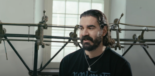 Close-up of someone sitting in front of a track sewing machine, in interview format.