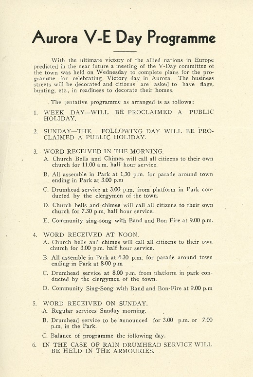 A creamed coloured piece of paper with black and white printed lettering listing the schedule of events for VE Day in Aurora