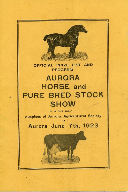 The front cover of a small rectangular program consisting of black lettering printed on a gold background with engraved illustrations of a horse and a cow all enclosed within a printed rectangular border