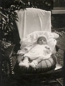 Photographie de Denyse Turcotte dans une chaise d’enfant, 1942