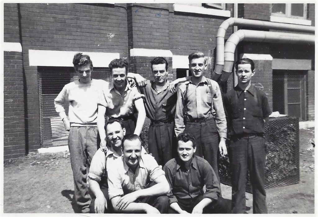 Period photograph of Mac Crozier and seven of his co-workers at De Havillands Ltd, 1942
