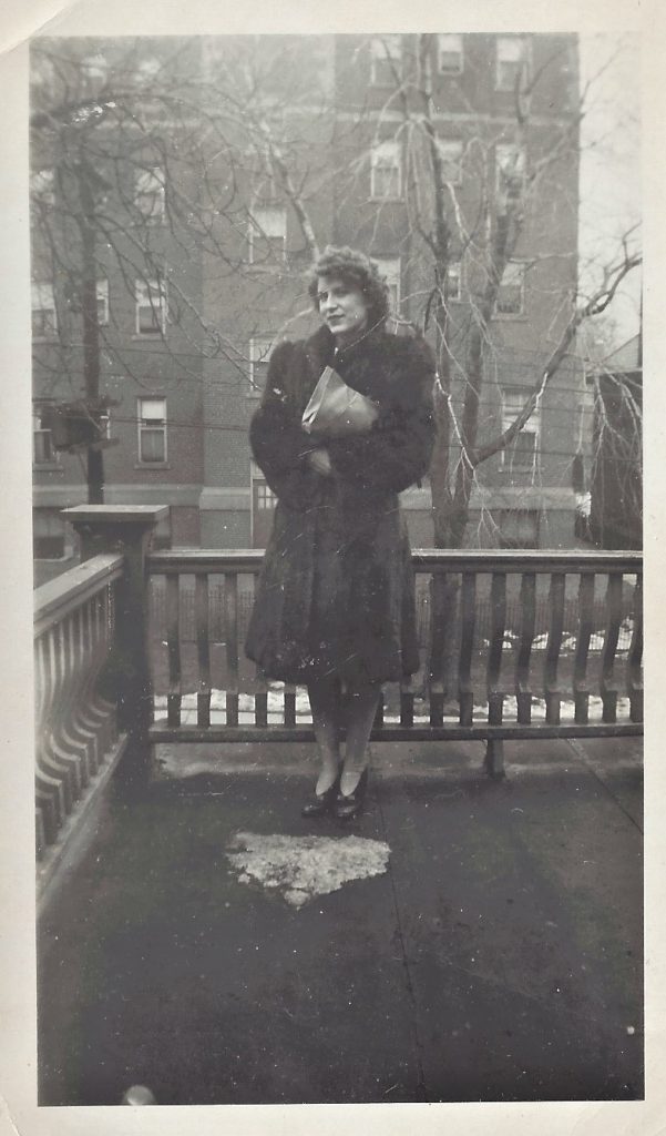 Photograph of Nora Pennett posing in a fur coat and clutching her purse in Toronto, 1942