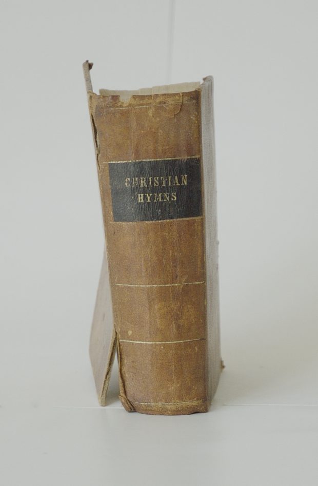 Leather bound book of christian hymns that was used at St. James in the 19th century.