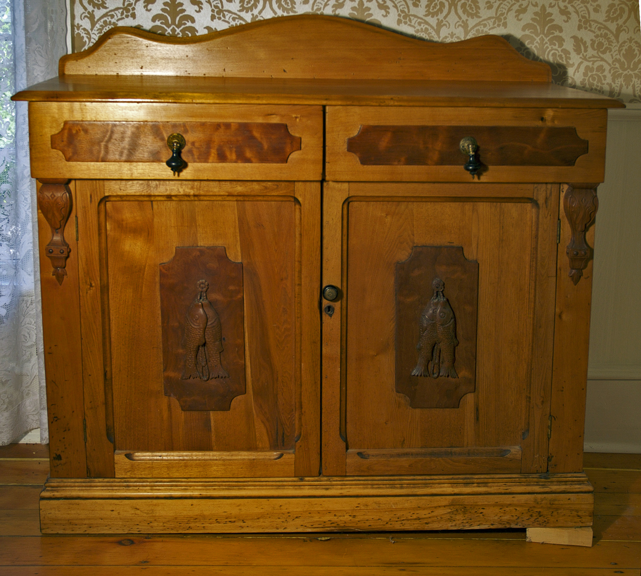 Large butternut oak sideboard for a dining room. Contains two drawers towards top, with two cupboards with doors under drawers underneath.