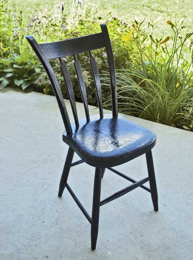 A black painted dining room chair