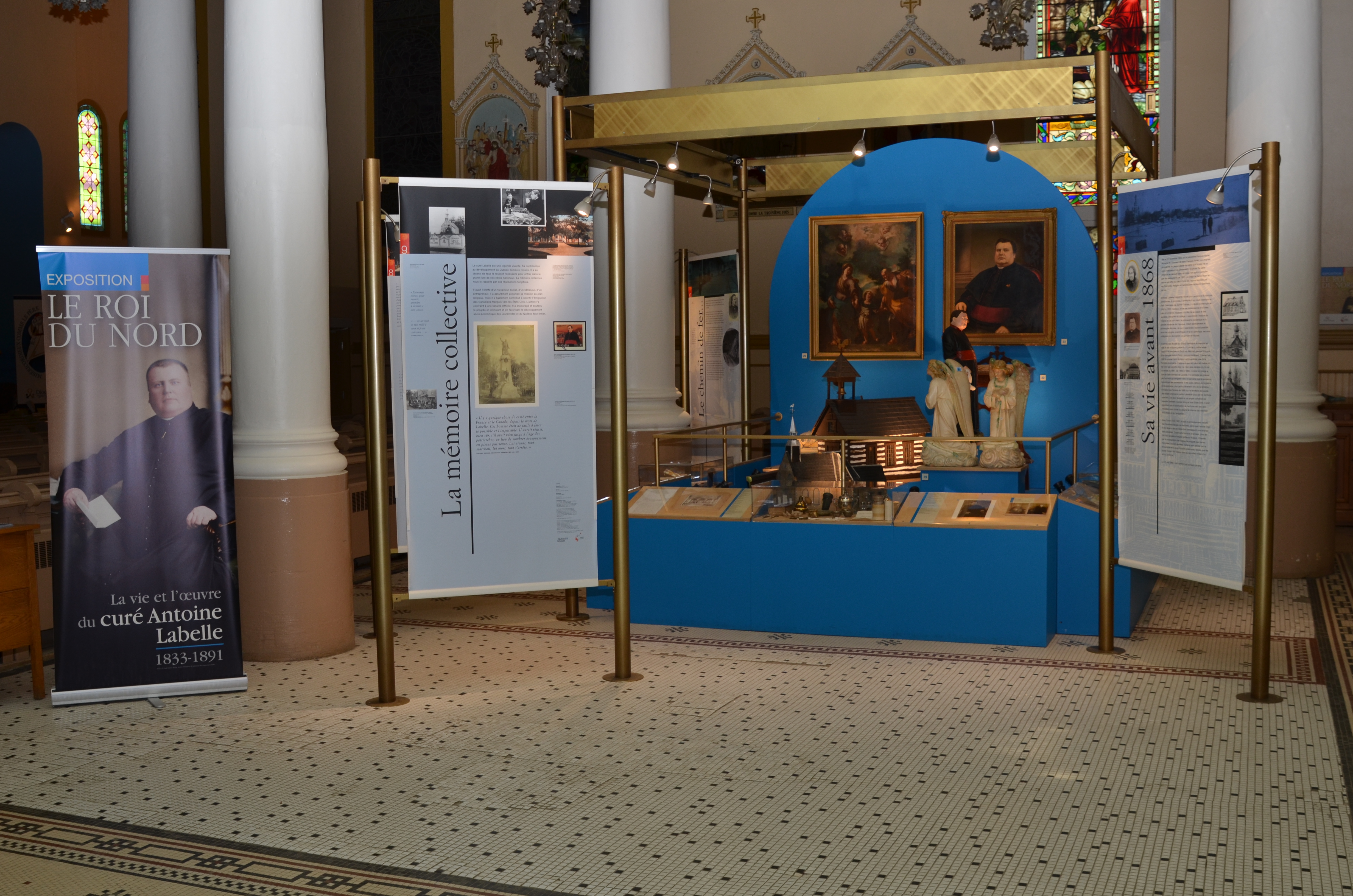 Colour photograph of exhibition panels with texts and images, surrounding display cases housing various objects.