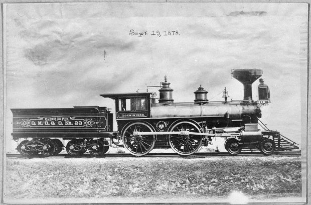 Black & white photograph of a steam locomotive on a railway. The date “Sept. 19, 1878” has been added to the photograph, above the locomotive. A small freight car is coupled to the locomotive.