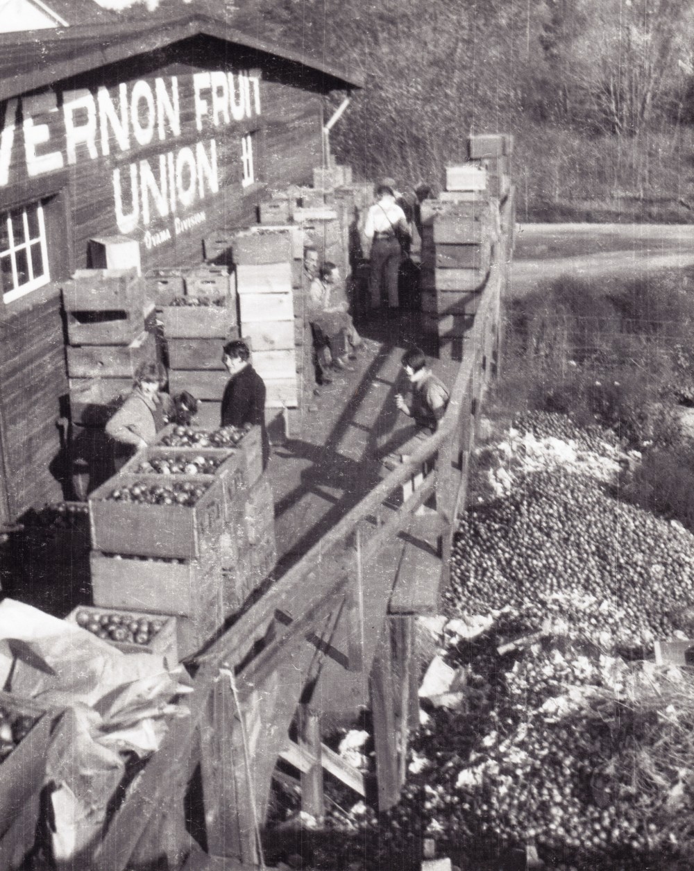 Black and white photo of a wooden building with the words 