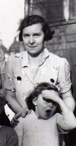 Black and white photo of a woman and a young girl standing outside.