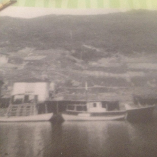 Black and white picture of boats in the harbour of the now resettled community of Port Elizabeth