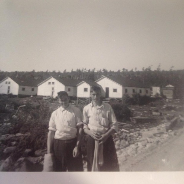 Wilson King and Thomas King in front of buildings in the lumber camp