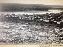 Logs in river. Town of Millertown, in the background