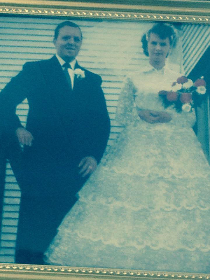 Mike and Priscilla Dicks standing on church steps on their wedding day 1960
