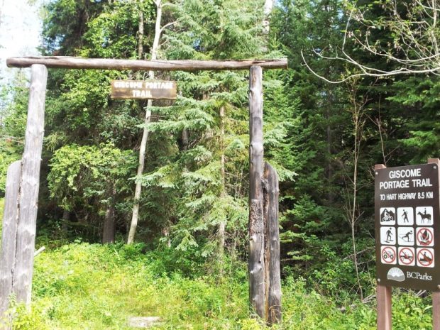 Giscome Portage Trail sign hanging from timber arch