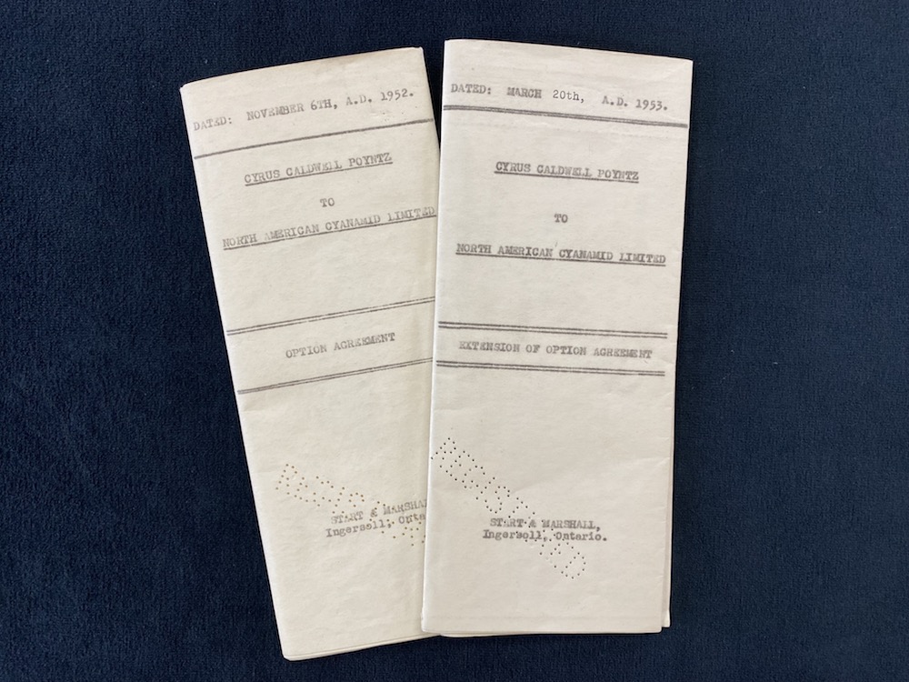 Two, folded documents with type-written dates and headings on the front and the punched word, 